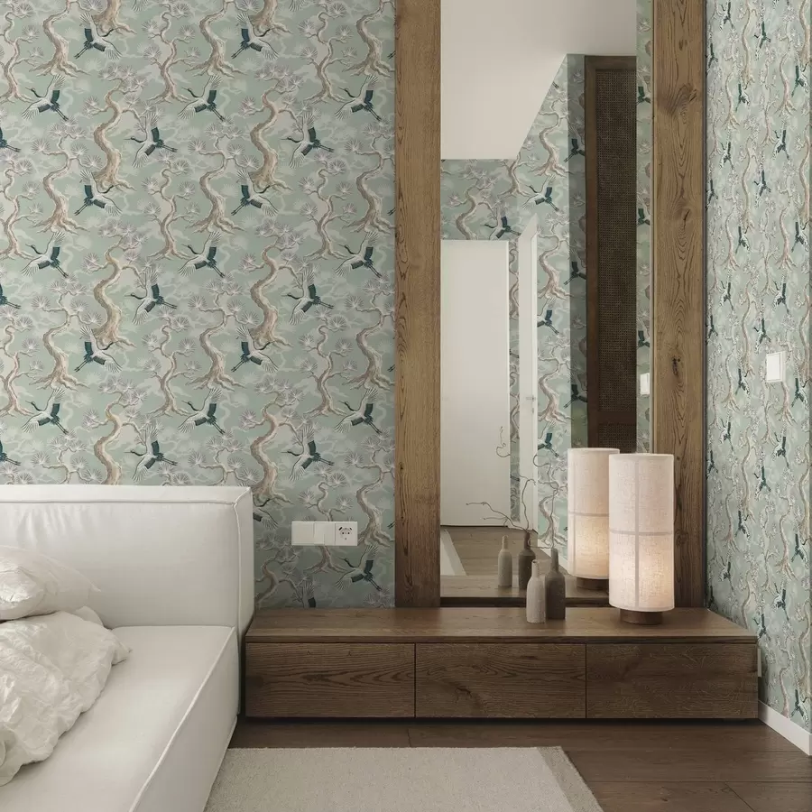 Papier peint Grues parmi les branches courbées sur un fond doux couleur sauge a01023